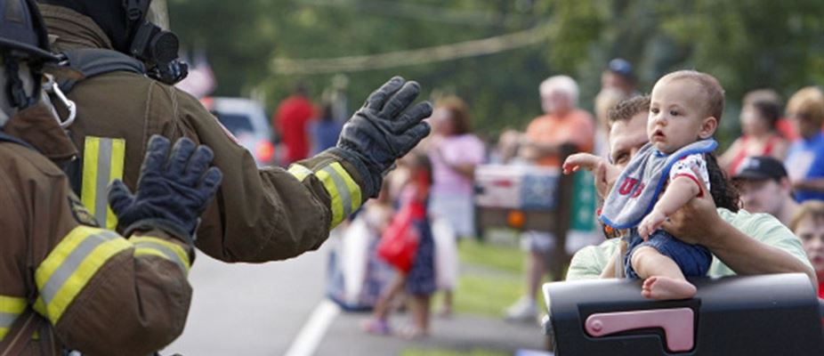 Fire Fighters waving at baby